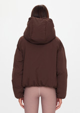 THE UPSIDE women's brown Mercer Hooded Puffer Jacket is fully lined and features invisible zip pockets with fleece lining, soft elasticated cuffs, a hood and is made from recycled fabric. Made for lifestyle.