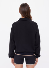 THE UPSIDE women's black organic cotton Collared Elle Polo is a relaxed fit long sleeve with a mocha stripe along ribbed hem and cuffs. Made for everyday wear.