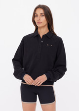 THE UPSIDE women's black organic cotton Collared Elle Polo is a relaxed fit long sleeve with a mocha stripe along ribbed hem and cuffs. Made for everyday wear.