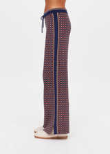THE UPSIDE women's brown organic cotton Lumiere Juniper Knit Pant is a straight leg pant with a geometric star pattern, a soft elasticated waistband with drawcord and side seam pockets. Made for lifestyle.
