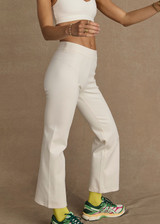 THE UPSIDE women's cream Bonnie Kick Flare Pant is a mid-rise, cropped flare pant made in a heavy ponte fabrication with a soft elastic waistband and embroidered arrow logo at back.