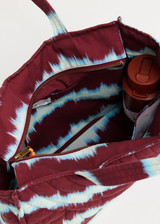 THE UPSIDE women’s tie dye organic cotton Rio Quilted Tote Bag has external and internal pockets, a waterbottle holder, and slips easily on suitcase. Made for lifestyle.