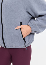THE UPSIDE women’s grey recycled Sol Fleece Jacket has a relaxed fit with elastic waist and arm cuffs with polar fleece fabrication in marle. Made for lifestyle.