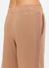 THE UPSIDE women's brown organic cotton Marlon Harrison Track Pant is true-to-size and features side stripes, side seam pockets and elasticated cuffs. Made for lifestyle.