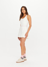 THE UPSIDE women’s cream recycled Kova Racerback Dress has built in shorts with pockets, a scooped front neckline with a racerback bra. Made for tennis.