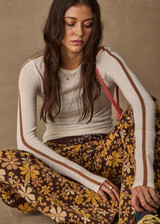 THE UPSIDE women's floral organic cotton Copacabana Juniper Knit Pant offers a soft and supportive fit with a straight leg silhouette, side stripes and drawcord waistband. Made for lifestyle.