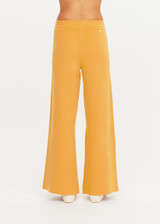 THE UPSIDE women's yellow organic cotton Bonito Moby Knit Pant is designed for a soft and supportive fit and features a high rise waist, side stripe detailing and adjustable drawcord. Made for lifestyle.