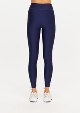 THE UPSIDE women’s navy recycled Eco Tech Salvador 25inch Midi Legging is mid rise and features side seam pockets, a cuffed hem and drawcord waist. Made for yoga and pilates.