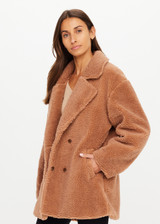 THE UPSIDE women’s brown recycled polyester Gracie Teddy Coat is a relaxed fit mid length coat and features a double breasted closure, welt pockets and faux shearling fabrication. Made for lifestyle.