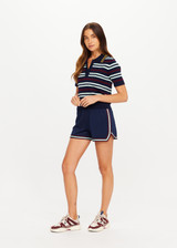 THE UPSIDE women’s stripe 100% organic cotton Archie Collared Knit Polo is true to size and features a striped rib collar, button front closure and ribbed hem. Made for tennis.