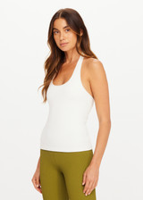 THE UPSIDE women's cream Seamless Halle Halter Top is a soft and supportive style featuring a scoop neckline, low back and built in shelf bra with removable cups. Made for yoga and pilates.