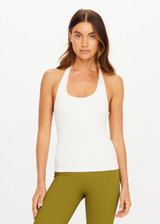 THE UPSIDE women's cream Seamless Halle Halter Top is a soft and supportive style featuring a scoop neckline, low back and built in shelf bra with removable cups. Made for yoga and pilates.