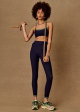 THE UPSIDE women's navy Rhythm 25inch Legging is a supportive and comfortable fit and features a mid rise waist, contrast side binding and streamlined rib fabrication. Made for yoga and pilates.