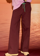 THE UPSIDE women's plum organic cotton Pele Estelle Pant is designed for a relaxed fit and features a wide leg barrel silhouette, elasticated waistband and contrast drawcord detailing. Made for lifestyle.