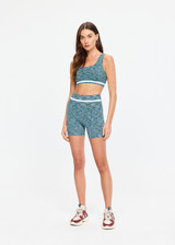 THE UPSIDE women's green Seamless 4inch Spin Short is designed for a supportive and comfortable fit and features a mid rise waist, seamless construction and ribbed striped waistband detailing. Made for yoga and pilates.