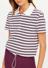 THE UPSIDE women's stripe organic cotton Sophie Cropped Polo Shirt is designed for a cropped fit and features a collared neckline, button front closure and adjustable drawcord hem detailing. Made for lifestyle.
