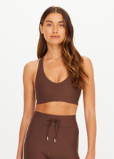 THE UPSIDE women's brown Daytona Jetta Racerback Sports Bra is designed for a soft and supportive fit and features a V neckline, contrast binding and removable cups. Made for yoga and pilates.