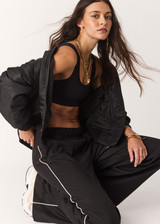 THE UPSIDE women's black lyocell linen blend Noir Elita Pant offers a true to size fit with a mid rise waist, contrast piping and slanted side seam pockets. Made for lifestyle.