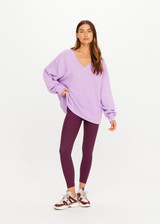 THE UPSIDE women's purple organic cotton Soul Lou V Neck Sweater offers an oversized fit with drop shoulders, ribbed trims and an embroidered logo detail. Made for lifestyle.
