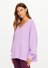 THE UPSIDE women's purple organic cotton Soul Lou V Neck Sweater offers an oversized fit with drop shoulders, ribbed trims and an embroidered logo detail. Made for lifestyle.