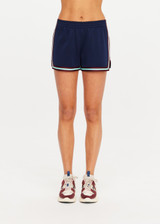 THE UPSIDE women’s navy recycled polyester Cleopatra Short features a mid rise elasticated waistband, curved hem with side splits, back pockets and contrast stripe tape detail. Made for lifestyle.