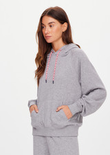 THE UPSIDE women's grey organic cotton Valley Raglan Hoodie offers a relaxed fit and features a hood with a pink drawcord and front patch pocket. The perfect everyday hoodie, made to last.