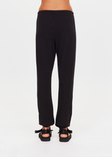 THE UPSIDE women's black organic cotton Kayne Track Pant is a classic mid-rise track pant and features a soft elasticated waistband with a brown paracord drawcord, elasticated cuffs and finished with a subtle embroidered arrow logo at back. The perfect everyday track pant, made to last.