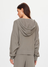 THE UPSIDE women's khaki organic cotton Jude Crop Hoodie is cut in a relaxed, slightly cropped silhouette and features a zip-through opening, a hood with a olive drawcord, ribbed cuffs and hem and front welt pockets. The perfect everyday hoodie, made to last.