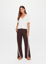 THE UPSIDE women’s natural Elina V Neck Tee is a boxy-fit style featuring a mini chest patch pocket and ribbed neckline with chocolate piping. Made for lifestyle.