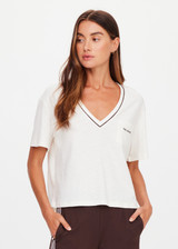 THE UPSIDE women’s natural Elina V Neck Tee is a boxy-fit style featuring a mini chest patch pocket and ribbed neckline with chocolate piping. Made for lifestyle.
