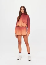 THE UPSIDE women's red Maya Ace Shell Jacket is designed for a cropped fit and features water-resistant, moisture-wicking, quick-dry fabric with four-way stretch. Made for running.