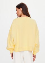 THE UPSIDE women's yellow organic cotton Paloma Crew is designed for a boxy fit and features a drop shoulder and ribbed neckline, hem and cuffs. Made for lifestyle.