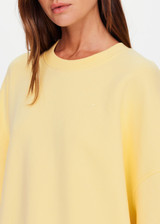 THE UPSIDE women's yellow organic cotton Paloma Crew is designed for a boxy fit and features a drop shoulder and ribbed neckline, hem and cuffs. Made for lifestyle.