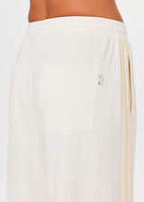 THE UPSIDE women's natural recycled polyester Roma Pant is high rise and features a butter mesh tape along side seams and back pockets with a logo pip. Made for lifestyle.