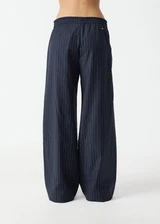 THE UPSIDE women's stripe Wool Elita Pant is a mid-rise, wide leg pant and features cream piping along side seams and maroon paracord drawcord. Made for lifestyle.