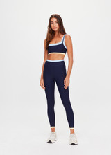THE UPSIDE women's navy recycled nylon Hermosa Ava Double Layer Bra is mid coverage and features a scooped neckline and contrast elasticated underbust  in butter. Made for yoga and pilates.