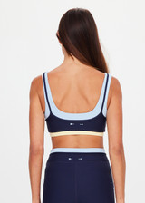 THE UPSIDE women's navy recycled nylon Hermosa Ava Double Layer Bra is mid coverage and features a scooped neckline and contrast elasticated underbust  in butter. Made for yoga and pilates.