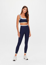 THE UPSIDE women's navy recycled nylon Hermosa 25 Inch Pocket Legging is mid rise and features a contrast hem cuff in butter and pockets at the side. Made for yoga and pilates.
