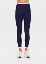 THE UPSIDE women's navy recycled nylon Hermosa 25 Inch Pocket Legging is mid rise and features a contrast hem cuff in butter and pockets at the side. Made for yoga and pilates.