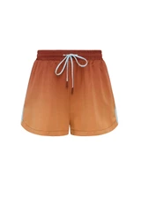 THE UPSIDE women's red recycled polyester Maya Billie Run Short is mid rise and features light blue mesh tape down side seams and side pockets. Made for running.