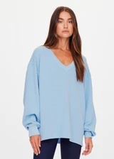 THE UPSIDE women's blue organic cotton Lou V Neck Sweater is an oversized fit and features dropped shoulders and a ribbed neckline and cuffs. Made for lifestyle.