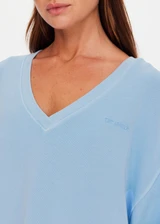 THE UPSIDE women's blue organic cotton Lou V Neck Sweater is an oversized fit and features dropped shoulders and a ribbed neckline and cuffs. Made for lifestyle.