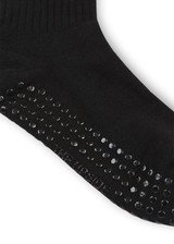 THE UPSIDE women’s black cotton Divina Grip Sock is anti slip and has a soft terry sole with bronze metallic stripes at ankle. Made for yoga and pilates.