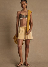 THE UPSIDE women's yellow Soho Dolci Short is designed for a high-rise, wide-leg silhouette with a elasticated waistband and front pockets, in soft brushed recycled cotton. Made for everyday leisure.