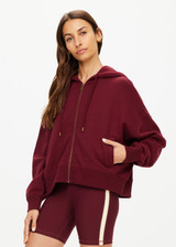 THE UPSIDE women's maroon oversized Ryder Jude Crop Zip-Up Hoodie is made from organic cotton and feature ribbed cuffs and a hemband.