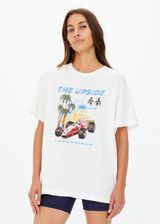 THE UPSIDE women's cream organic cotton Raceway Sammi Tee is designed for an oversized fit with printed raceway graphics on the front.