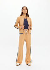THE UPSIDE women's yellow Le Sport Margot Zip Jacket is designed for a slim fit and features pockets and textured knit side tapes. Perfect for travel and everyday.