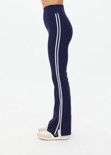 THE UPSIDE women's navy recycled peached Florence Flare Pant is a high-rise pant in a breathable fabric, featuring cream side stripes. Perfect for pilates.