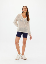 THE UPSIDE women's creme organic cotton Josephine V Neck Knit is a lightweight open knit designed for a relaxed fit with a deep V neckline. Made for everyday.