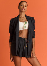 THE UPSIDE women's navy pinstripe merino Wool Cadiz Pleated Skirt features an inner short and pockets with elasticated waistband. Perfect for tennis and pickleball. THE UPSIDE women's navy pinstripe merino Wool Cadiz Pleated Skirt features an inner short and pockets with elasticated waistband. Perfect for tennis and pickleball.